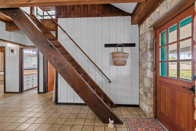 interior space featuring vaulted ceiling and stairway