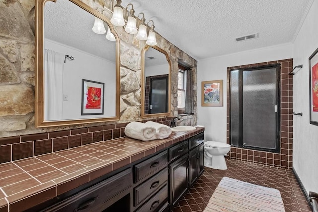 full bathroom featuring visible vents, toilet, a stall shower, vanity, and tile patterned flooring