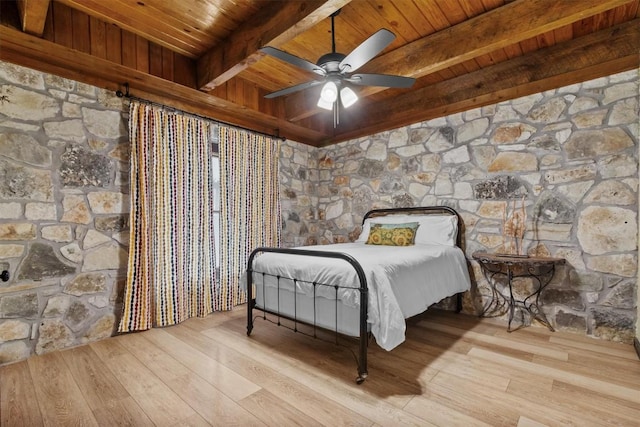 bedroom featuring wood ceiling, beam ceiling, and wood finished floors