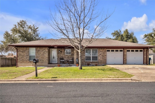 ranch-style home featuring an attached garage, a front lawn, concrete driveway, and brick siding