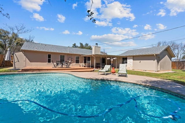 view of pool with a patio area, a fenced in pool, and fence