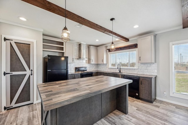 kitchen featuring wall chimney exhaust hood, butcher block countertops, beam ceiling, black appliances, and backsplash