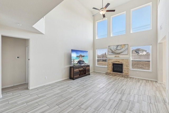 20417 Whimbrel Ct, Pflugerville, TX 78660 - living room with a ceiling fan, high vaulted ceiling, baseboards, plenty of natural light, and a fireplace
