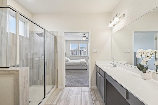 20417 Whimbrel Ct, Pflugerville, TX 78660 - ensuite bathroom featuring vanity, a stall shower, baseboards, and a ceiling fan