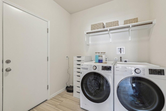 20417 Whimbrel Ct, Pflugerville, TX 78660 - washroom with washer and clothes dryer, baseboards, and light wood-style flooring