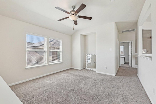 unfurnished bedroom with carpet floors, lofted ceiling, visible vents, a ceiling fan, and baseboards