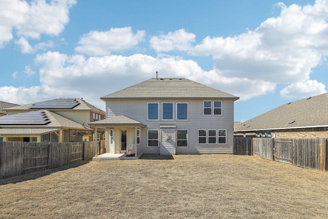 rear view of property with a patio area, a fenced backyard, and a lawn