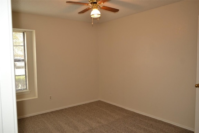 spare room featuring carpet floors, ceiling fan, and baseboards