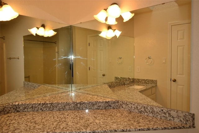 full bathroom featuring walk in shower, a sink, and double vanity