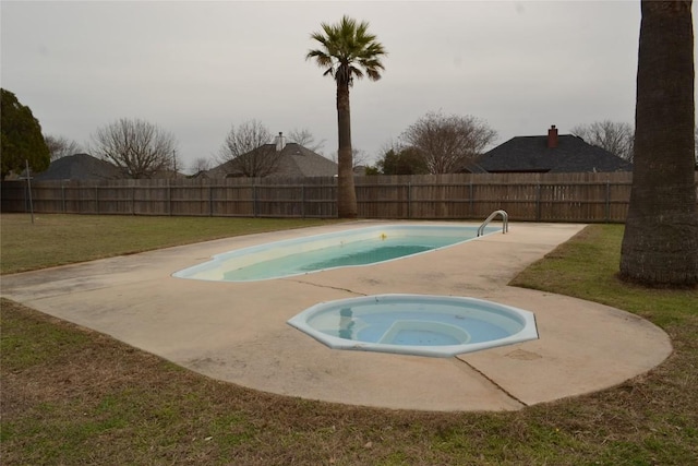 view of swimming pool with a patio area, a fenced backyard, a lawn, and an in ground hot tub