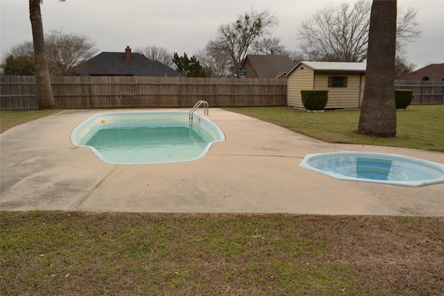 view of pool featuring a yard, an outdoor structure, a fenced backyard, and a fenced in pool