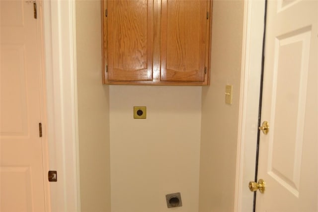 washroom with cabinet space and hookup for an electric dryer