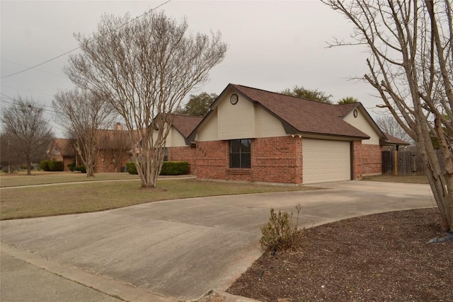 view of side of home with driveway, a shingled roof, a lawn, an attached garage, and brick siding