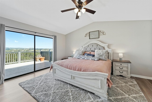 bedroom featuring baseboards, lofted ceiling, ceiling fan, wood finished floors, and access to exterior