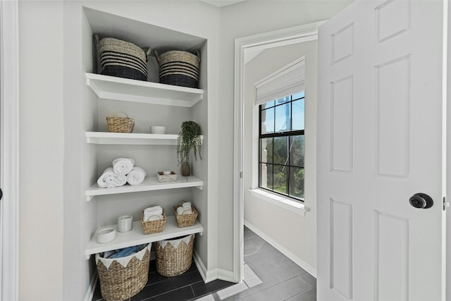 doorway featuring baseboards