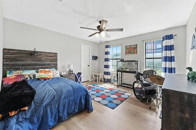 bedroom with a ceiling fan and wood finished floors