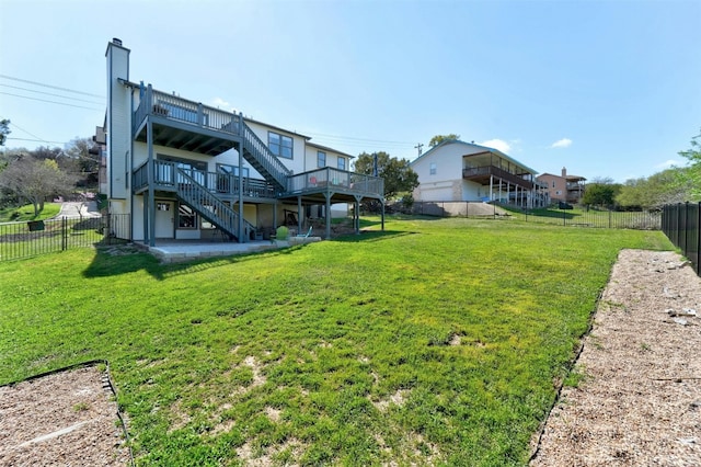 view of yard featuring stairs, a fenced backyard, and a wooden deck