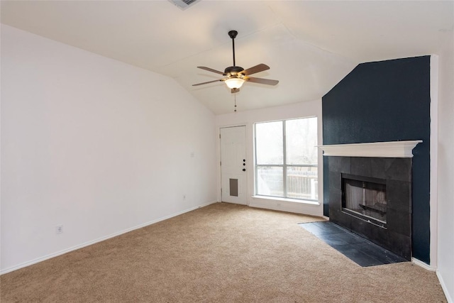121 Winecup Path, Cedar Creek, TX 78612 - unfurnished living room featuring vaulted ceiling, carpet flooring, ceiling fan, and a tile fireplace