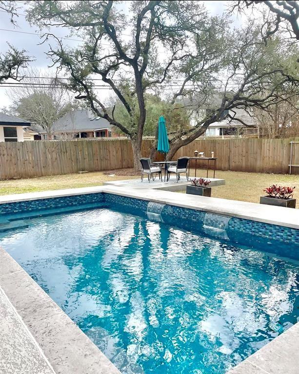 view of swimming pool with a fenced in pool, a fenced backyard, and a patio