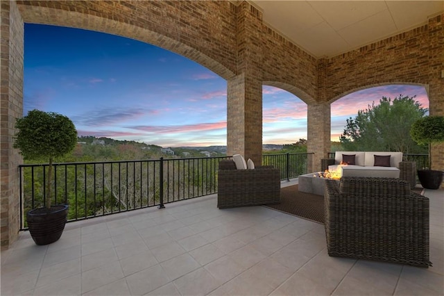 patio terrace at dusk featuring an outdoor living space