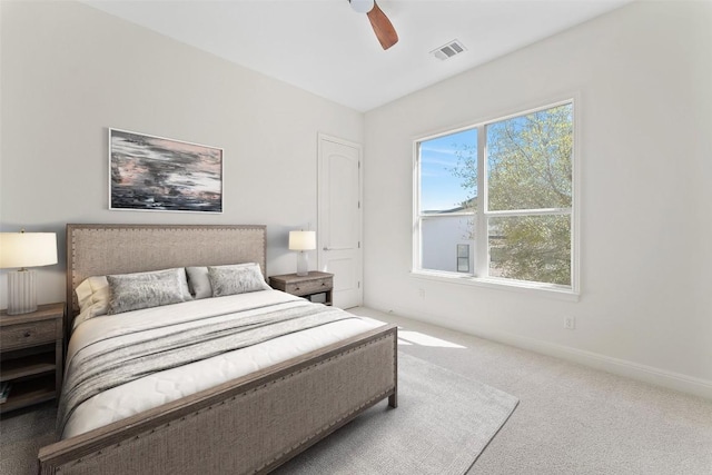 bedroom with carpet floors, ceiling fan, visible vents, and baseboards