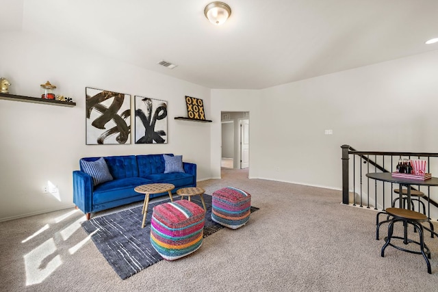 carpeted living room featuring visible vents and baseboards