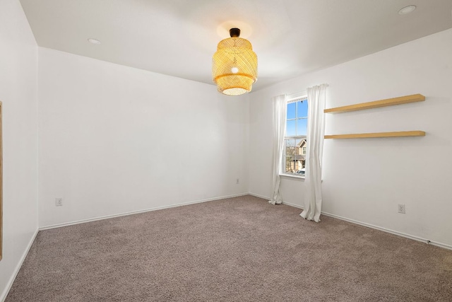 carpeted empty room with baseboards