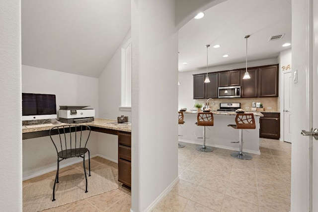 office area featuring visible vents, arched walkways, built in study area, light tile patterned flooring, and recessed lighting