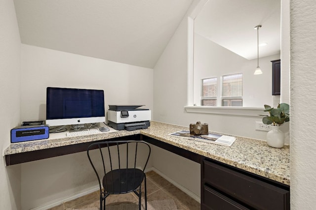 office space with tile patterned flooring, built in study area, and vaulted ceiling