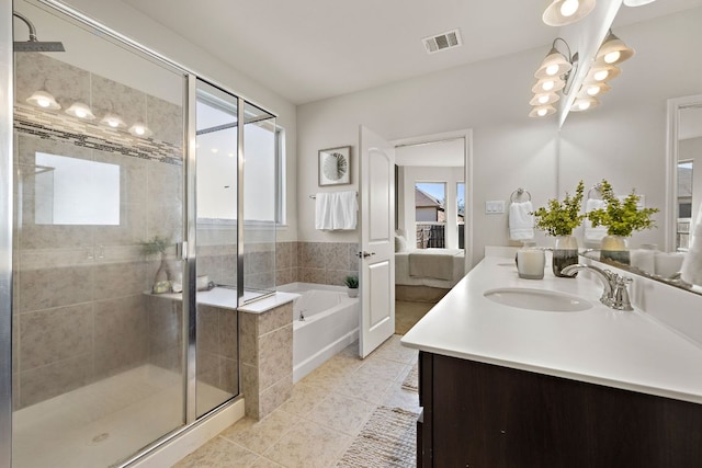 full bath with visible vents, connected bathroom, tile patterned flooring, a shower stall, and a bath