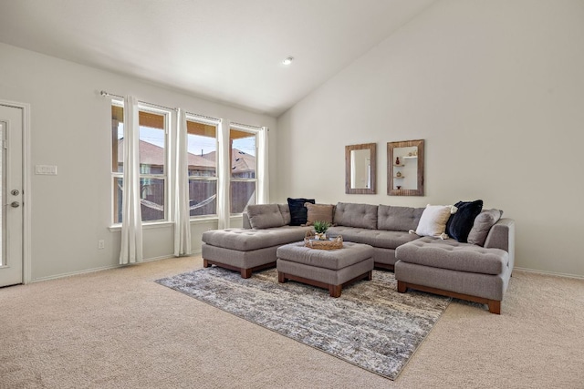 living area with carpet, vaulted ceiling, and baseboards