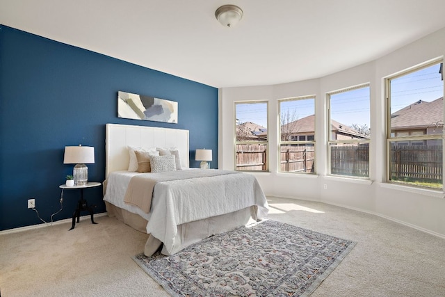 carpeted bedroom featuring baseboards