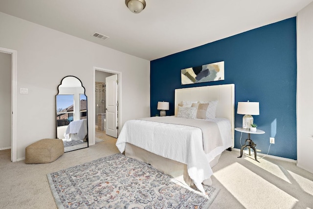 carpeted bedroom with baseboards and visible vents