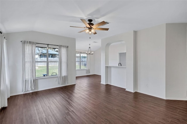 17616 Strontian Pass, Pflugerville, TX 78660 - unfurnished living room featuring dark wood-style floors, a ceiling fan, arched walkways, a chandelier, and vaulted ceiling
