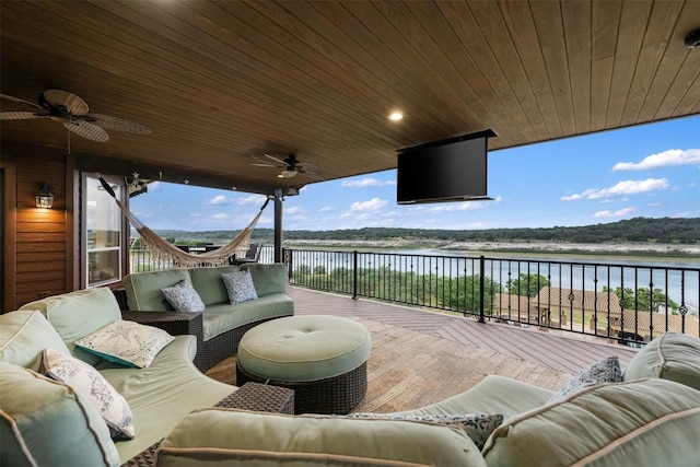 wooden deck featuring outdoor lounge area and a ceiling fan