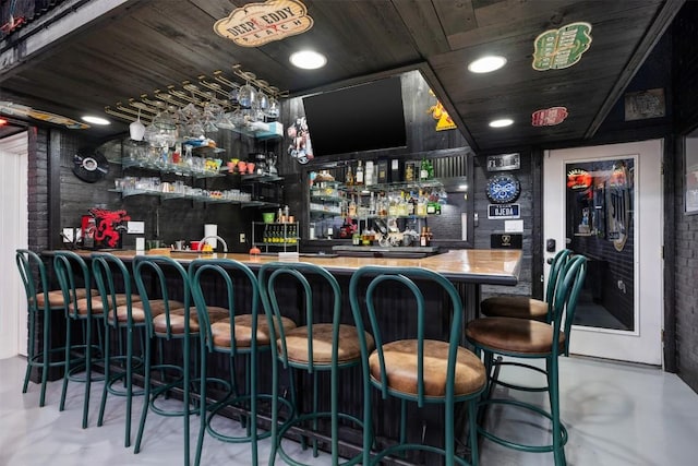 bar with a community bar, wood ceiling, finished concrete floors, and recessed lighting