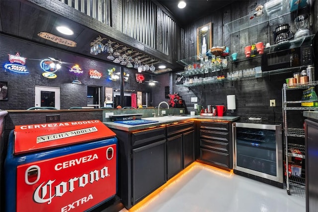 community bar area featuring beverage cooler, a high ceiling, finished concrete floors, and black microwave