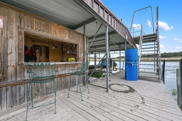 exterior space with stairs, a water view, and boat lift