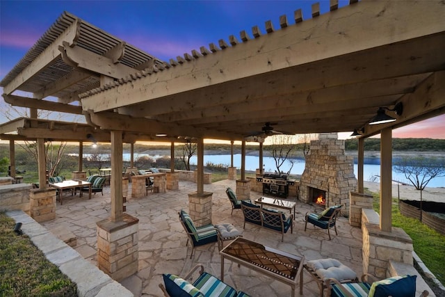 view of patio / terrace featuring an outdoor living space with a fireplace, a water view, a grill, and a pergola