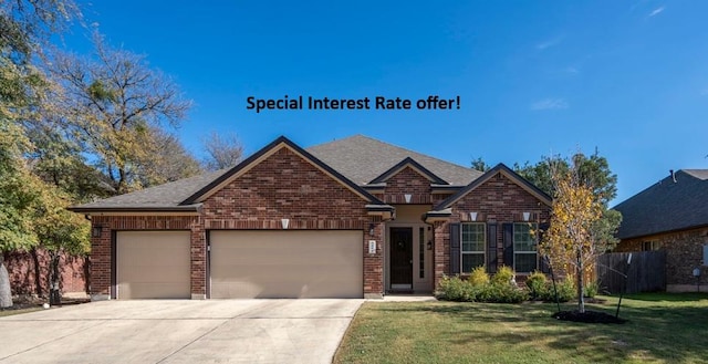 view of front of property with driveway, brick siding, an attached garage, and a front yard