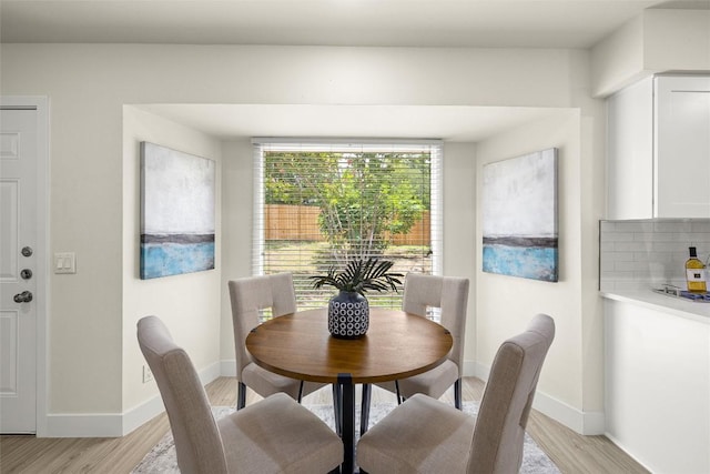 dining room with light wood-type flooring and baseboards