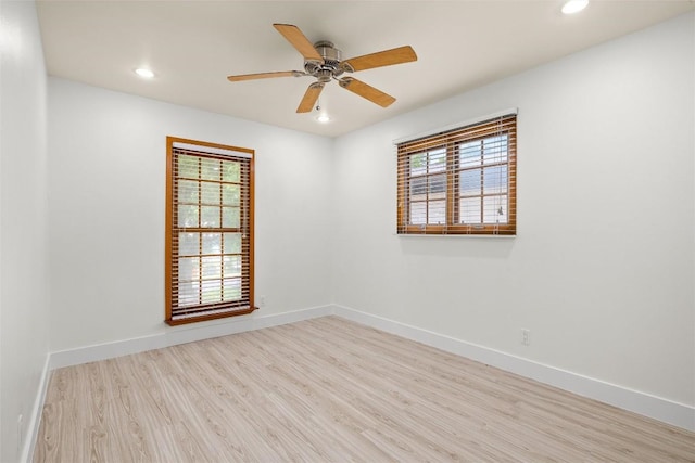 unfurnished room featuring recessed lighting, wood finished floors, and baseboards