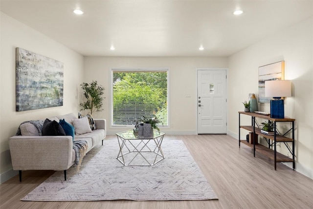 living room with recessed lighting, light wood-type flooring, and baseboards