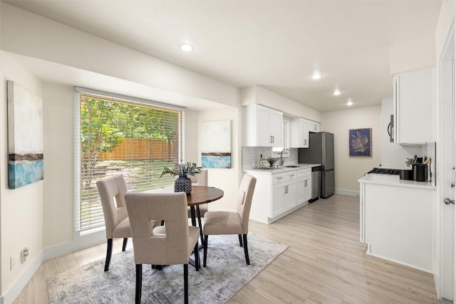 dining area featuring recessed lighting, light wood-type flooring, and baseboards