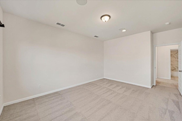 unfurnished room featuring carpet floors and baseboards
