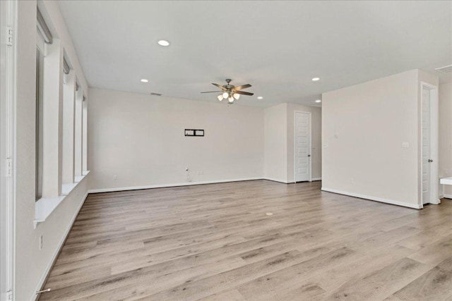 unfurnished room with a ceiling fan, recessed lighting, light wood finished floors, and baseboards