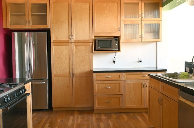 4708 Shoalwood Ave, Austin, TX 78756 - kitchen featuring appliances with stainless steel finishes, wood finished floors, and glass insert cabinets