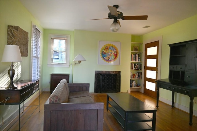 4708 Shoalwood Ave, Austin, TX 78756 - living room featuring a fireplace, wood finished floors, built in features, and a ceiling fan