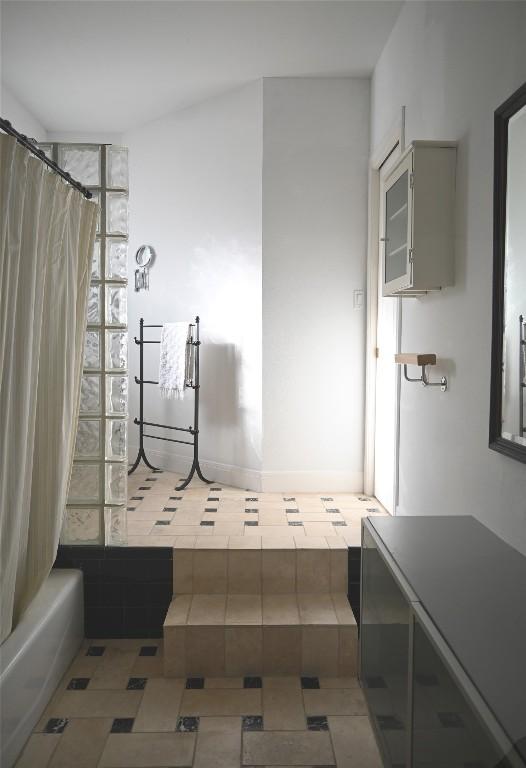 4708 Shoalwood Ave, Austin, TX 78756 - bathroom featuring shower / bath combo with shower curtain and tile patterned flooring