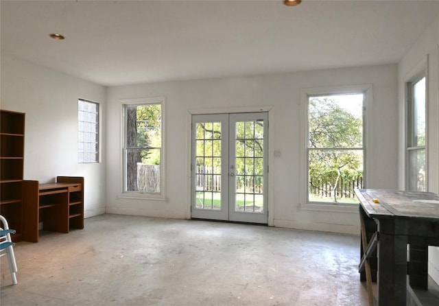 interior space with concrete flooring and baseboards